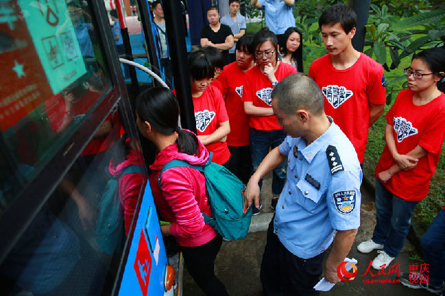 5月8日，重庆“青年志愿者警察营” 正式开班。图为警方用真实公交车，搭建模拟公交站台，由反扒民警现场模拟上公交车时的扒窃手法，并教授防扒技能。刘政宁 摄