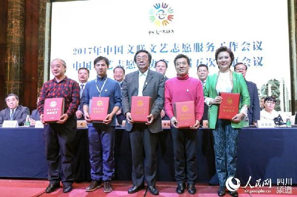 中国文联文艺志愿服务工作会议在成都举行，“最美志愿者”上台领奖。（朱虹 摄）